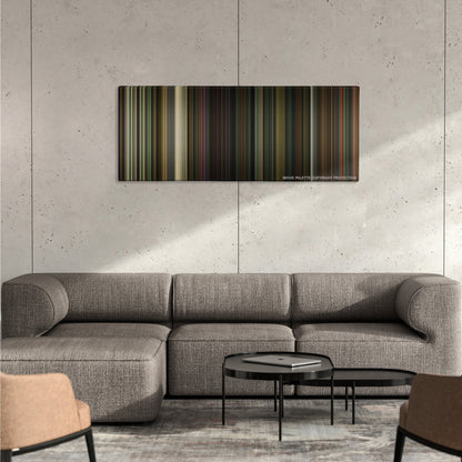The Nice Guys color palette canvas on a concrete wall above a gray sectional sofa