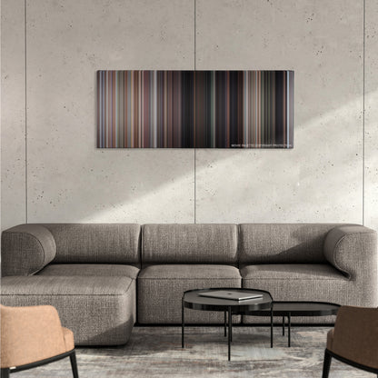 Commando color palette canvas on a concrete wall above a gray sectional sofa