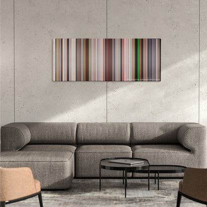 Bruno color palette canvas on a concrete wall above a gray sectional sofa