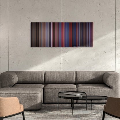 The Running Man color palette canvas on a concrete wall above a gray sectional sofa