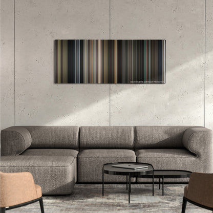 Annabelle color palette canvas on a concrete wall above a gray sectional sofa
