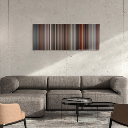 JFK color palette canvas on a concrete wall above a gray sectional sofa