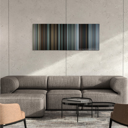 The Gift color palette canvas on a concrete wall above a gray sectional sofa