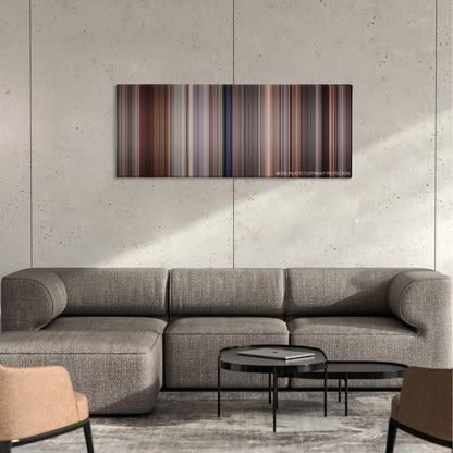Bull Durham color palette canvas on a concrete wall above a gray sectional sofa