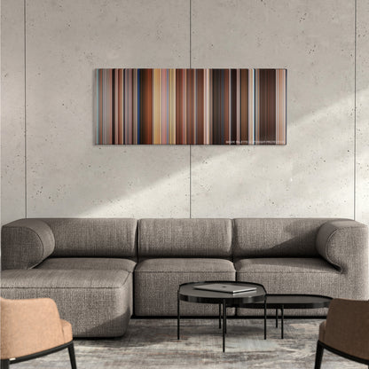 Blue Is the Warmest Colour color palette canvas on a concrete wall above a gray sectional sofa