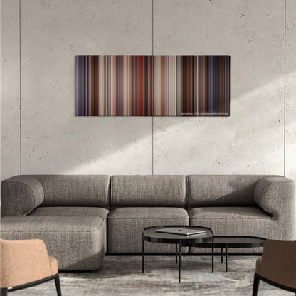 Last Action Hero color palette canvas on a concrete wall above a gray sectional sofa