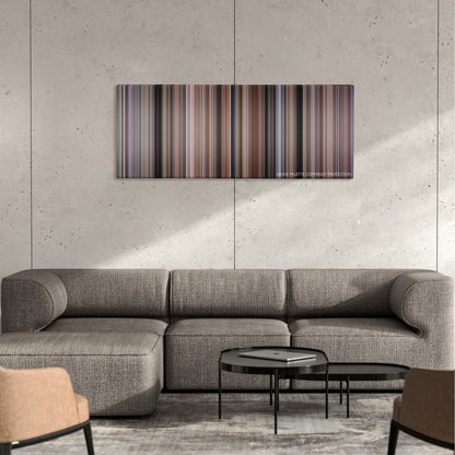 Tommy Boy color palette canvas on a concrete wall above a gray sectional sofa