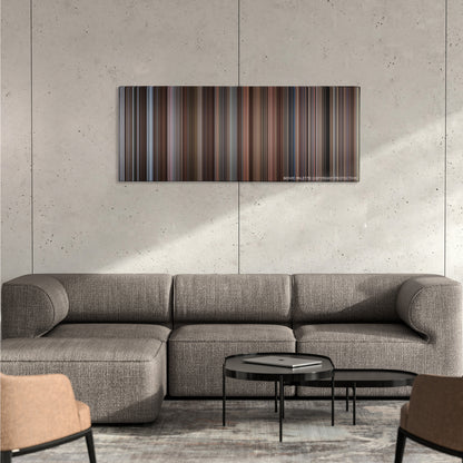 Trading Places color palette canvas on a concrete wall above a gray sectional sofa
