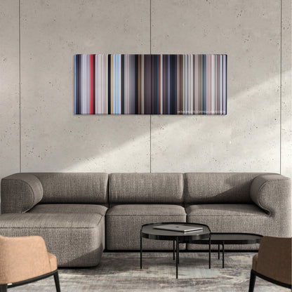 Superman color palette canvas on a concrete wall above a gray sectional sofa