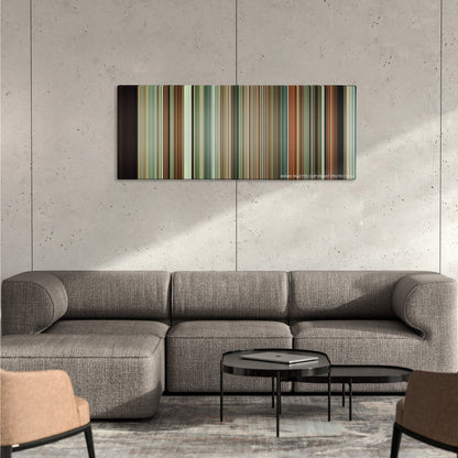 A Serious Man color palette canvas on a concrete wall above a gray sectional sofa