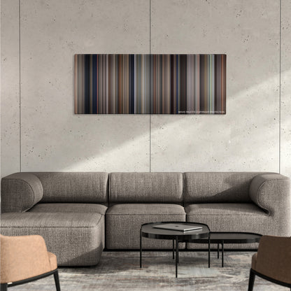 The Untouchables color palette canvas on a concrete wall above a gray sectional sofa
