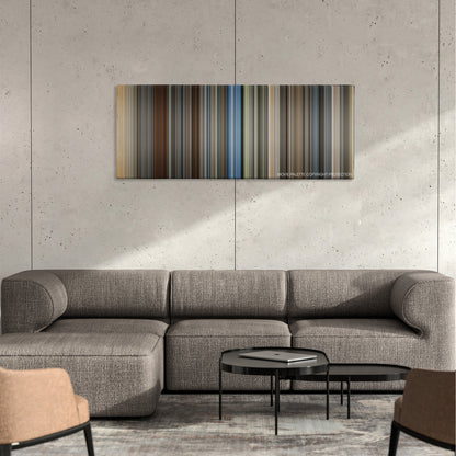 Christopher Robin color palette canvas on a concrete wall above a gray sectional sofa