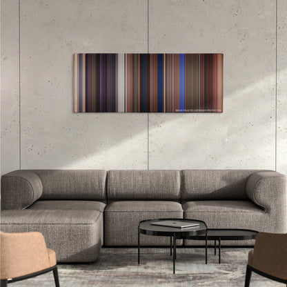 Chasing Amy color palette canvas on a concrete wall above a gray sectional sofa