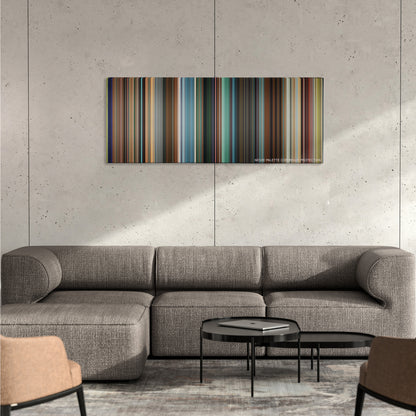 Pixels color palette canvas on a concrete wall above a gray sectional sofa