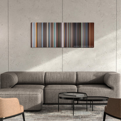Stay color palette canvas on a concrete wall above a gray sectional sofa