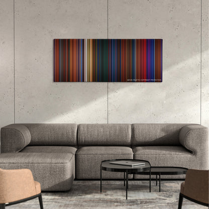 Peter Pan color palette canvas on a concrete wall above a gray sectional sofa