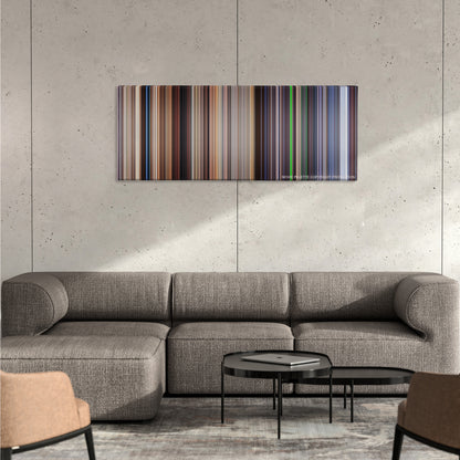 The Truman Show color palette canvas on a concrete wall above a gray sectional sofa