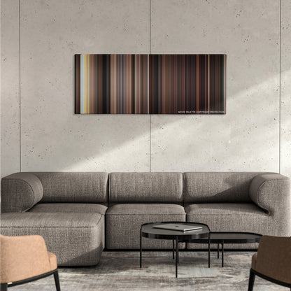 Carrie color palette canvas on a concrete wall above a gray sectional sofa