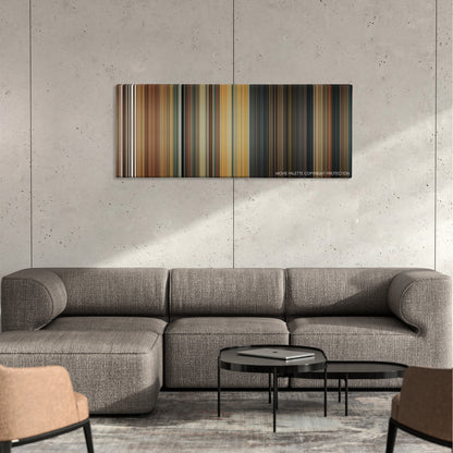 The Producers color palette canvas on a concrete wall above a gray sectional sofa
