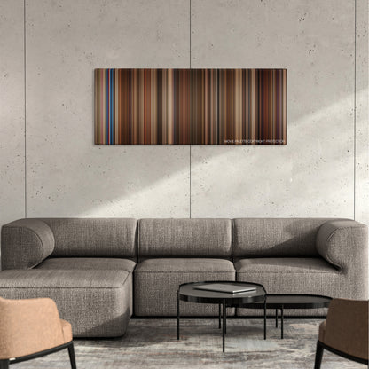 The Pink Panther color palette canvas on a concrete wall above a gray sectional sofa