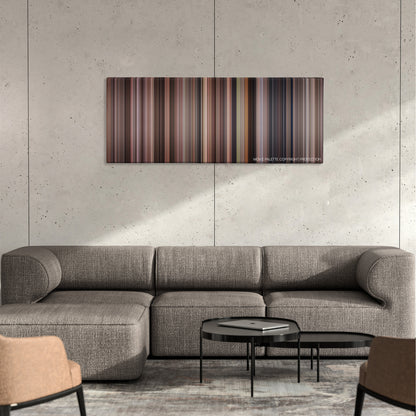 Benny & Joon color palette canvas on a concrete wall above a gray sectional sofa