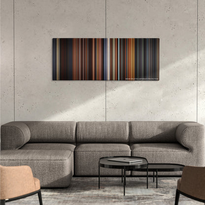 Little Women color palette canvas on a concrete wall above a gray sectional sofa