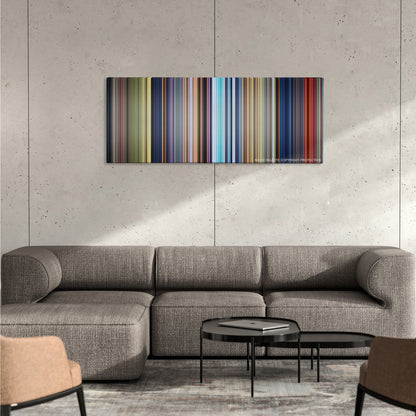 Bambi color palette canvas on a concrete wall above a gray sectional sofa