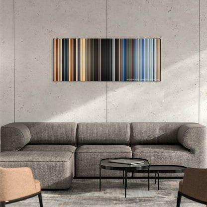 The Old Guard color palette canvas on a concrete wall above a gray sectional sofa