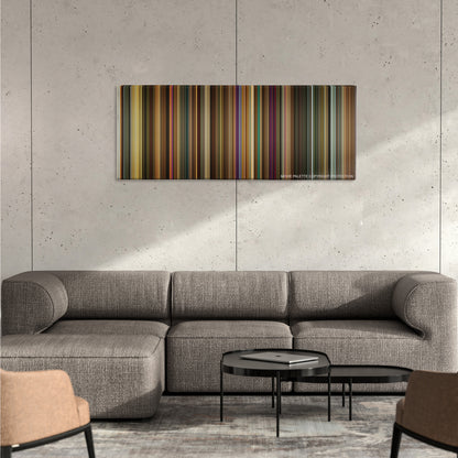Across the Universe color palette canvas on a concrete wall above a gray sectional sofa