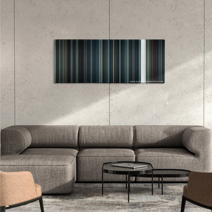 Arrival color palette canvas on a concrete wall above a gray sectional sofa