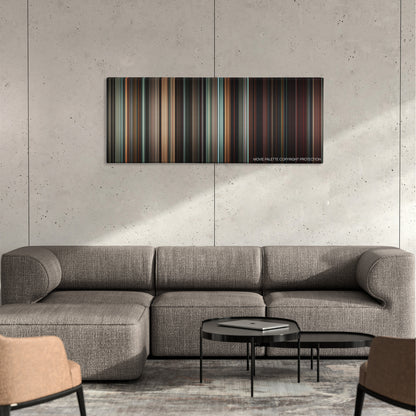Suspiria color palette canvas on a concrete wall above a gray sectional sofa