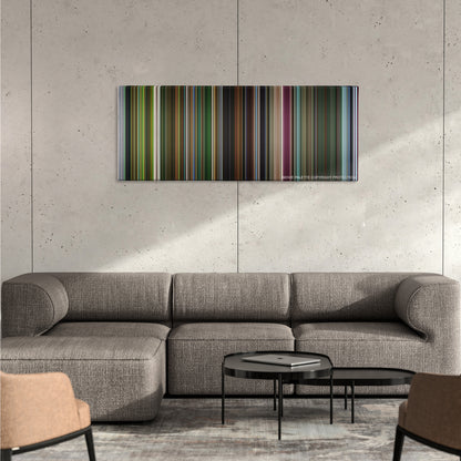 Oldboy color palette canvas on a concrete wall above a gray sectional sofa