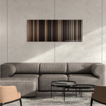 Tombstone color palette canvas on a concrete wall above a gray sectional sofa