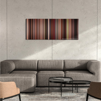 Spartacus color palette canvas on a concrete wall above a gray sectional sofa
