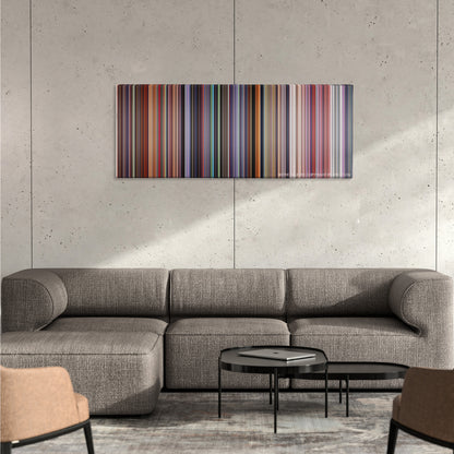 Akira color palette canvas on a concrete wall above a gray sectional sofa