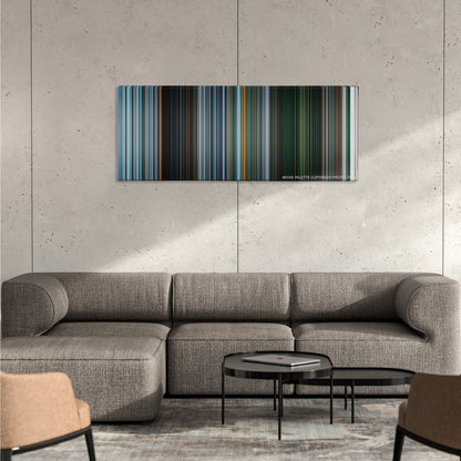 Gravity color palette canvas on a concrete wall above a gray sectional sofa