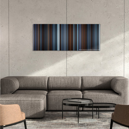 Reign of Fire color palette canvas on a concrete wall above a gray sectional sofa