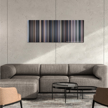 Cinema Paradiso color palette canvas on a concrete wall above a gray sectional sofa