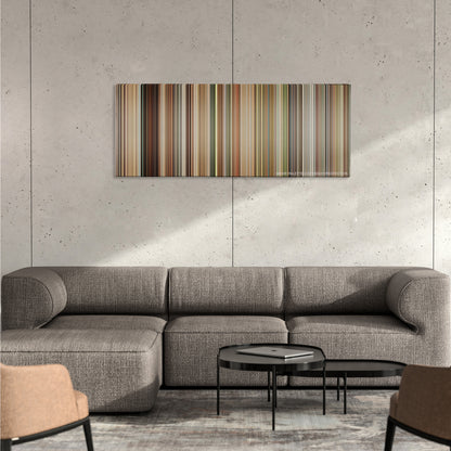 The Queen color palette canvas on a concrete wall above a gray sectional sofa