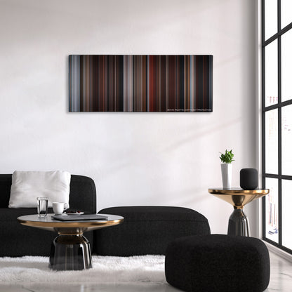 Fifty Shades of Grey color palette canvas above a black sofa with a gold-topped table