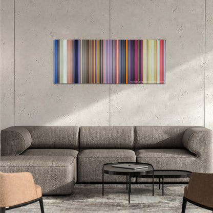 Dumbo color palette canvas on a concrete wall above a gray sectional sofa