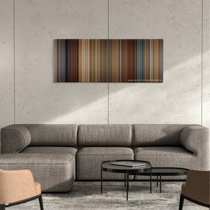 Wanderlust color palette canvas on a concrete wall above a gray sectional sofa