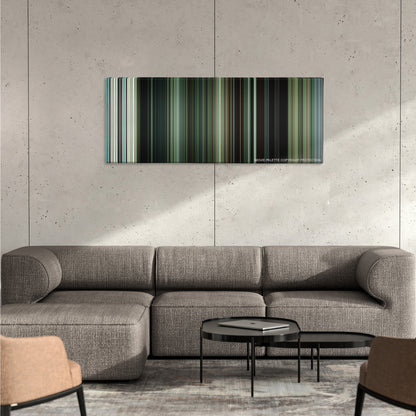 Swiss Army Man color palette canvas on a concrete wall above a gray sectional sofa
