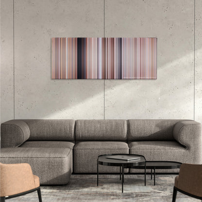 Tremors color palette canvas on a concrete wall above a gray sectional sofa