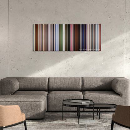 Up color palette canvas on a concrete wall above a gray sectional sofa