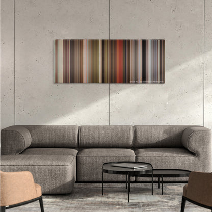 Blazing Saddles color palette canvas on a concrete wall above a gray sectional sofa