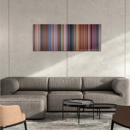 Peter Pan color palette canvas on a concrete wall above a gray sectional sofa