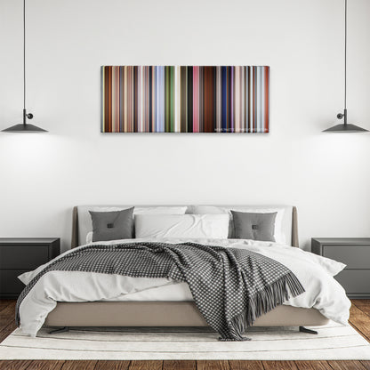 Up color palette canvas above a bed, between two black pendant lamps