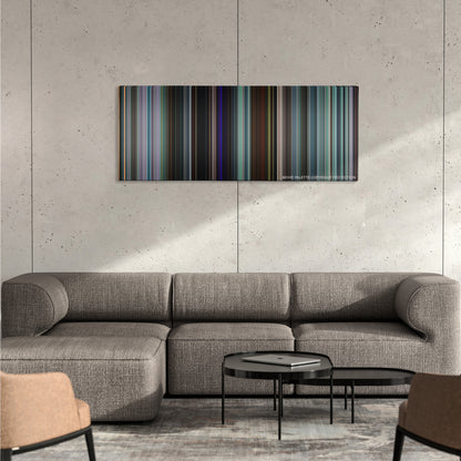 Uncut Gems color palette canvas on a concrete wall above a gray sectional sofa