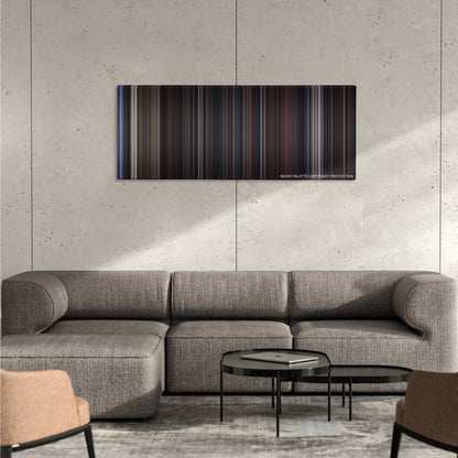 The Addams Family color palette canvas on a concrete wall above a gray sectional sofa